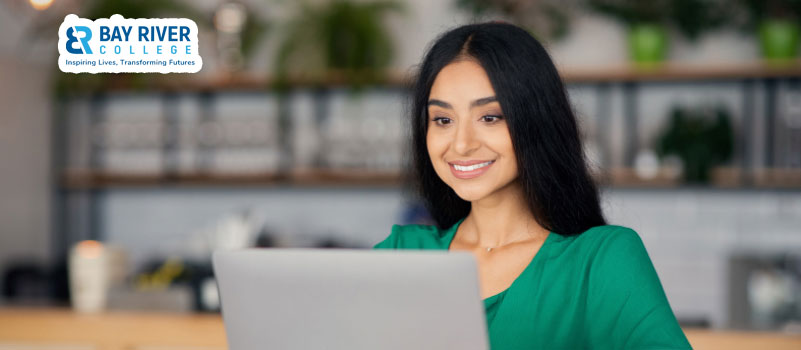 College in Canada a student happy woman studying working with laptop