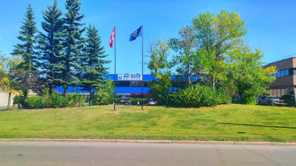 Bay River College Building Canada Flag Alberta Flag spring sunny day Calgary Alberta Canada private college