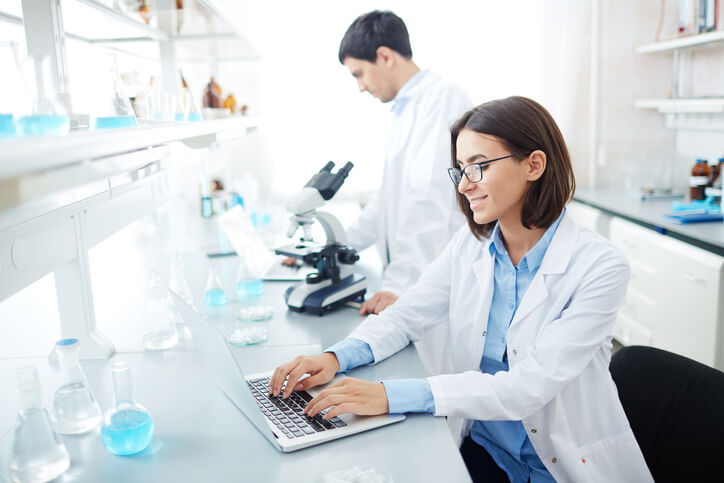 A female clinical research coordinator interacting with a colleague