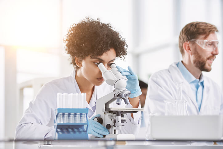 A focused female clinical researcher conducting clinical trials after graduating from a career college