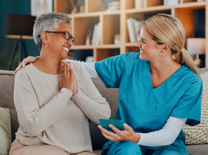 A female community support worker interacting with an elderly female client