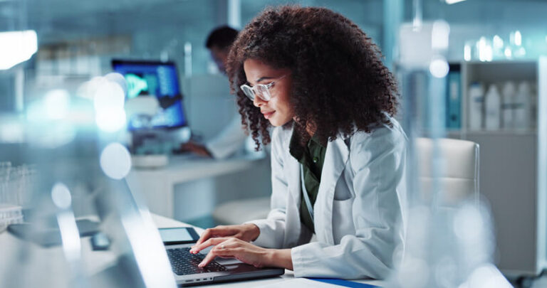 A female clinical researcher working in a laboratory after graduating from a career college