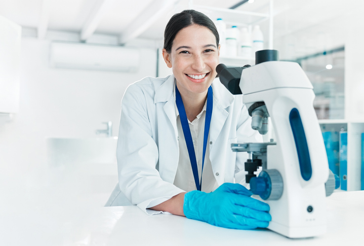 clinical research coordinator using a microscope