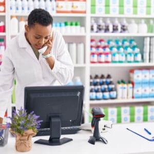 pharmacy assistant diploma program grad doing inventory management on a computer