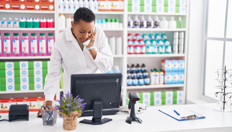 pharmacy assistant diploma program grad doing inventory management on a computer