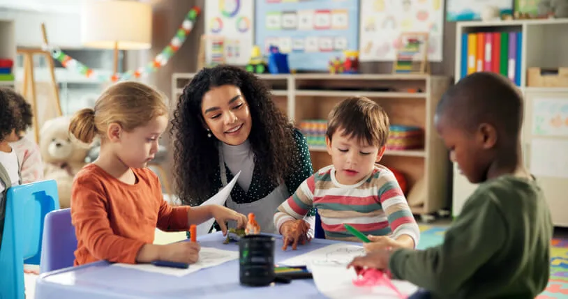 An Education assistant helping pupils with reading