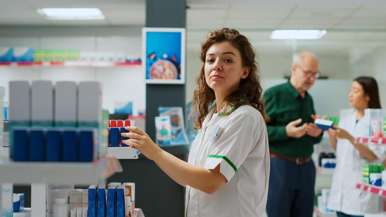 A student practicing pharmacy assistant skills during training