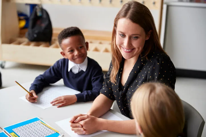 Teacher assistants in Alberta providing one-on-one support to children in class