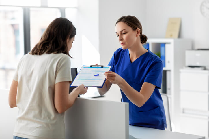 A medical office assistant supporting patient intake, demonstrating her medical office assistant responsibilities