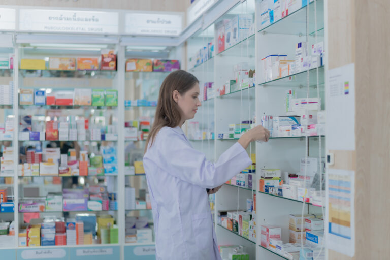 Pharmacy assistant organizing medication inventory