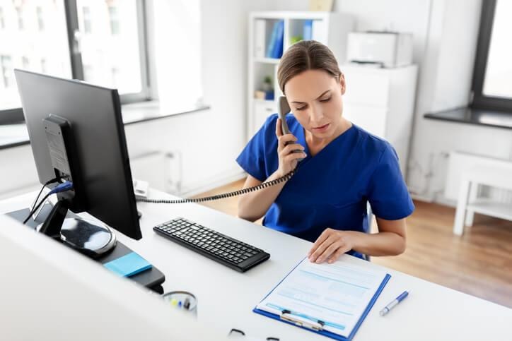 A medical admin organizing patient files in a healthcare office