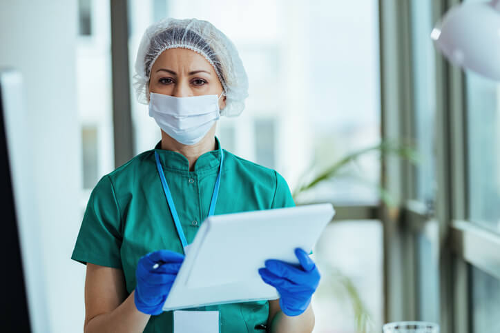 An infection control nurse reviewing patient care protocols