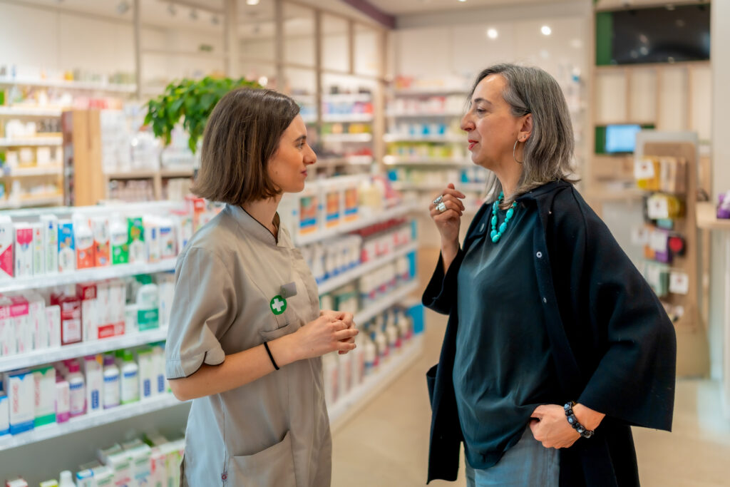 Pharmacy assistant assisting a customer at the counter