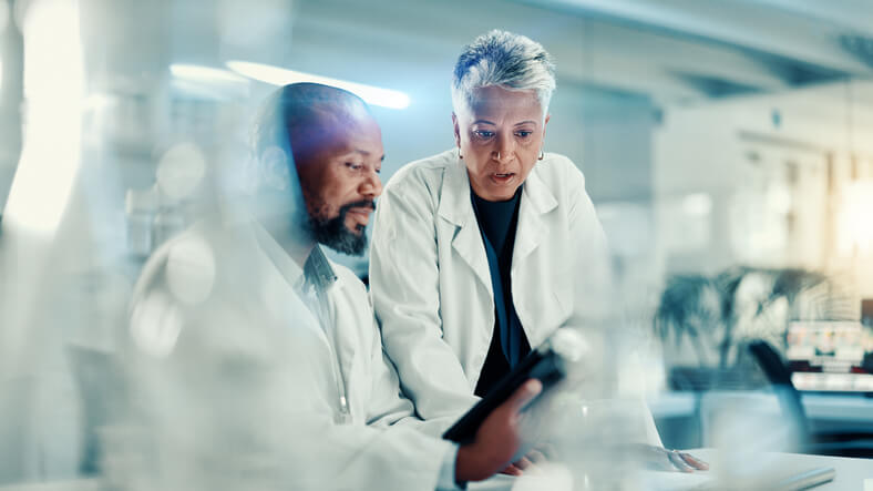 Clinical research coordinator interacting with a clinical research associate during a clinical trial