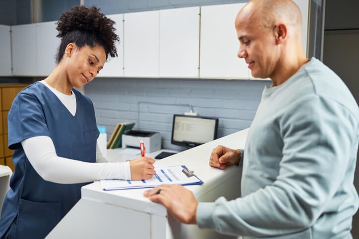 A medical office administrator's skills in assisting patients at reception