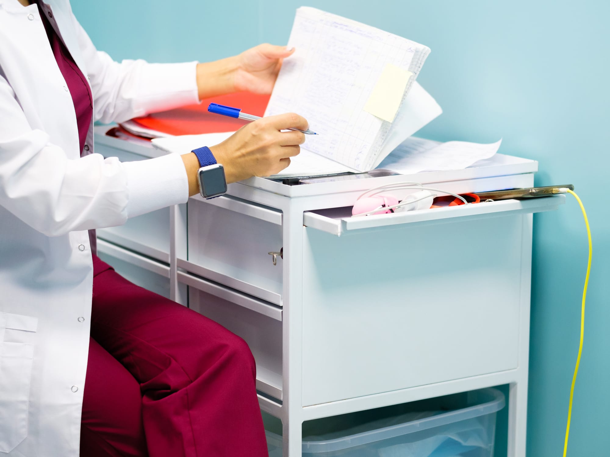 Clinical research assistant organizing trial documentation in a research office