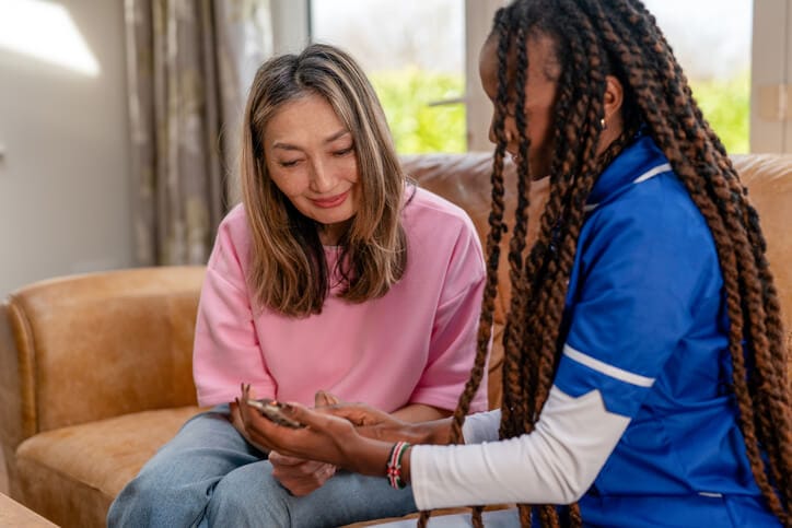 A community support worker assisting a client at home