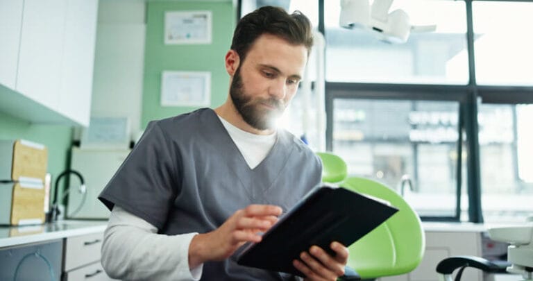 Clinical research assistant reviewing clinical trial documentation in a research office