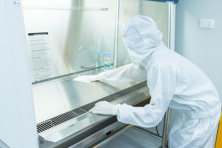 An environmental technician using testing equipment in a laboratory
