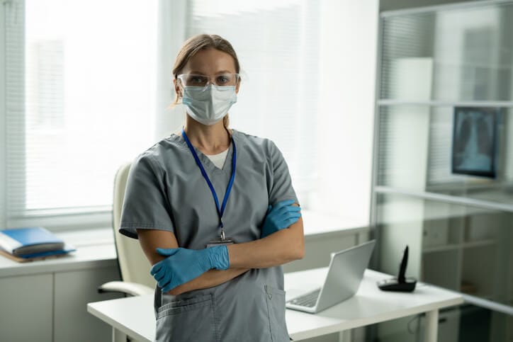 An infection control practitioner reviewing sanitation protocols in a hospital environment
