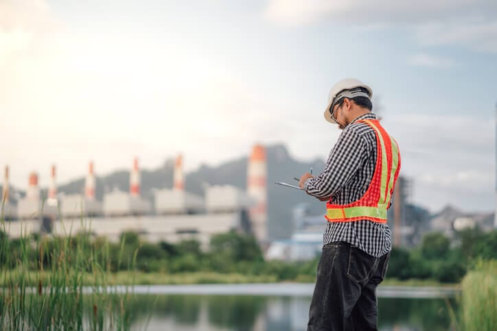 An environmental technician conducting environmental site inspections at an industrial facility