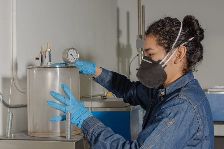 An environmental technology student using environmental testing equipment during lab training