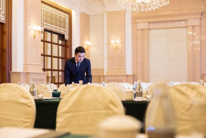 Event manager in hospitality management overseeing corporate event setup in a banquet hall