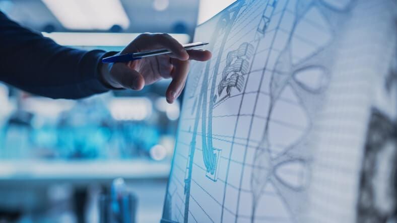 A process piping drafter creating technical piping drawings using CAD software