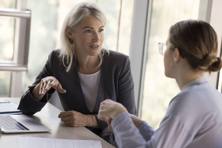 An education assistant collaborating with a teacher to implement an Individual Education Plan
