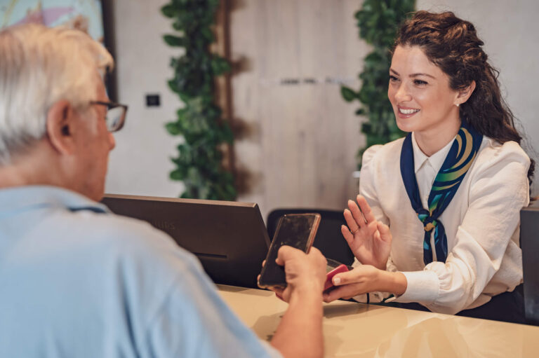 A hospitality student practising customer service communication with a hotel guest