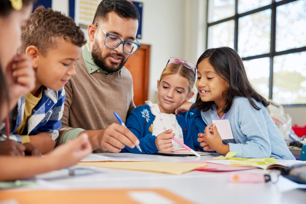 Education Assistant supporting a student during a classroom activity