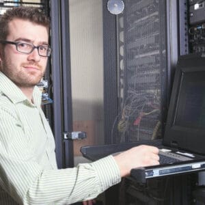 Network administrator student configuring computer networking equipment