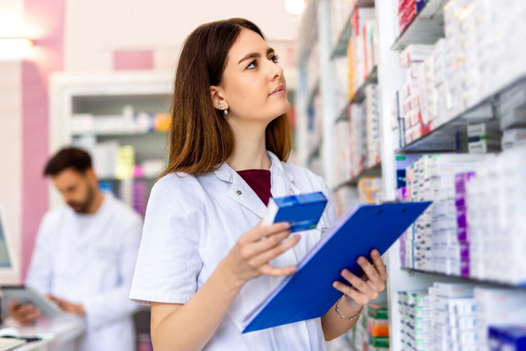 A pharmacy assistant locating medication inventory for prescription processing