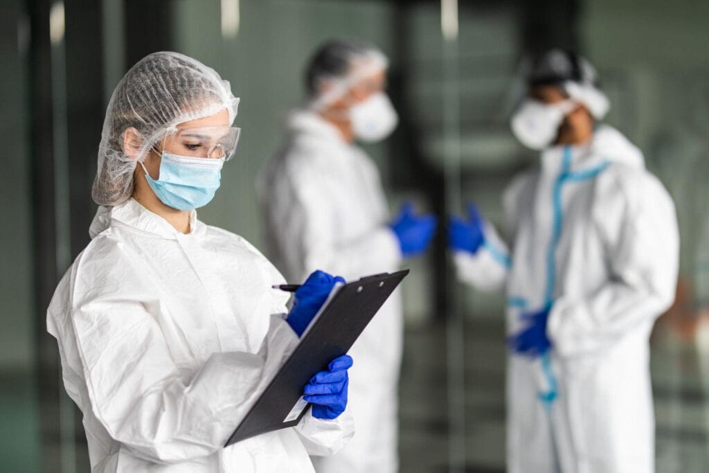 An infection prevention team creating a line list during an outbreak investigation