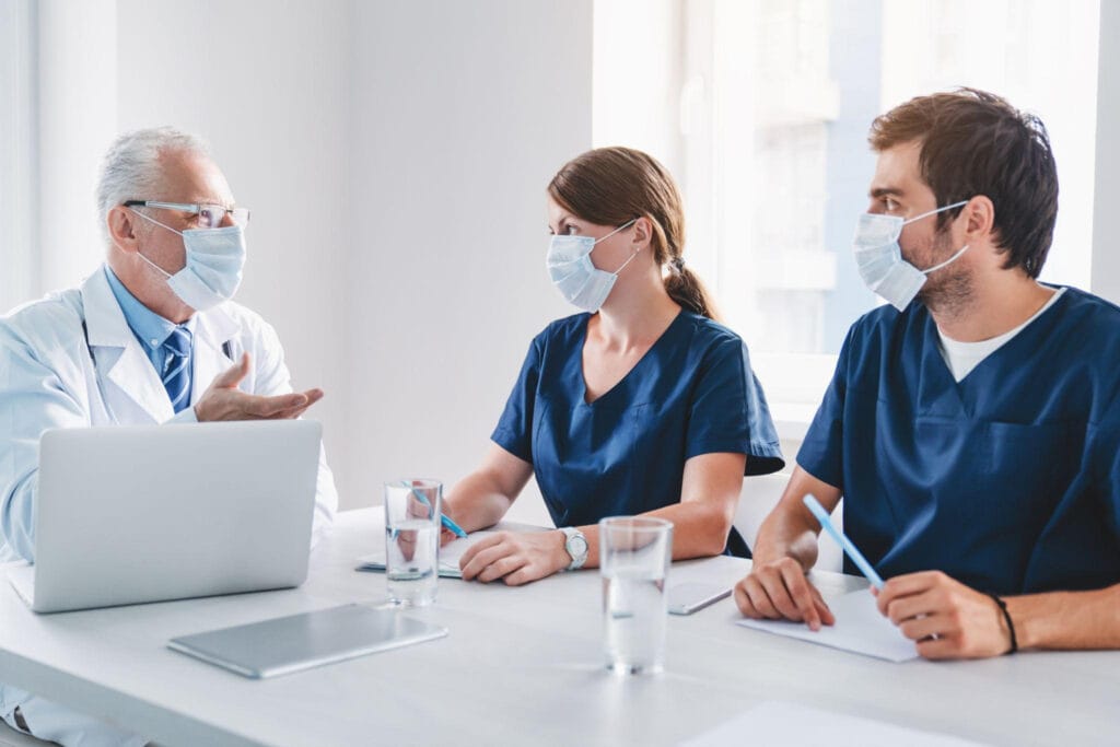 A team of healthcare professionals meeting to coordinate outbreak control measures